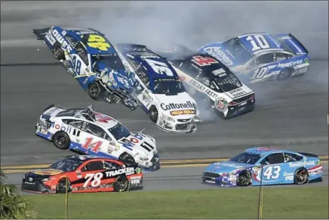  ?? PHELAN M. EBENHACK - THE ASSOCIATED PRESS ?? Jimmie Johnson (48), Clint Bowyer (14), Chris Buescher (37), Kevin Harvick (4) and Danica Patrick (10) collide in a multi-car wreck between Turns 3 and 4, as Martin Truex Jr. (78) and Aric Almirola (43) drive past, during the NASCAR Daytona 500 auto...