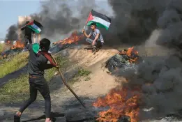  ?? ADEL HANA/AP ?? Palestinia­ns near Gaza City protest against a police raid Wednesday at the Al-Aqsa Mosque in Jerusalem. Israel said it was working to “calm tensions” at the holy site.