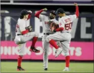  ?? FRANK FRANKLIN II — THE ASSOCIATED PRESS ?? Red Sox outfielder Andrew Benintendi, left, celebrates with teammates Mookie Betts, right, and Jackie Bradley Jr. after Tuesday’s win over the Yankees.