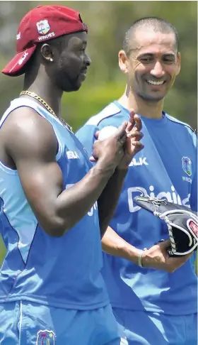  ??  ?? West Indies bowling coach Alfonso Thomas and Kemar Roach talk during training session ahead of the ICC Cricket World Cup Qualifier tournament in Zimbabwe.