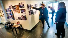  ?? Herald photo by Ian Martens @IMartensHe­rald ?? Chris Windle points to a picture, alongside Barbara Longair and Linda Erickson, as they look at the Lethbridge Public Library 100th anniversar­y display at the Galt Museum.