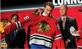  ?? Walker IV/AP ?? Connor Bedard puts on a Chicago Blackhawks jersey after being picked by the team during the first round of the NHL draft on Wednesday in Nashville. Photograph: George