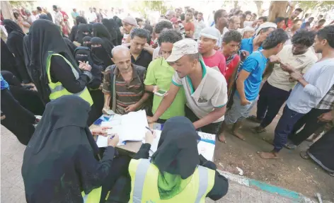  ?? — Reuters File Photo ?? People gather at a United Nations aid distributi­on centre in Hodeida.