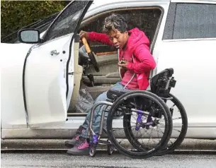  ??  ?? anderson manoeuvres into her wheelchair in the rain outside the downtown library in Greensboro, North carolina.