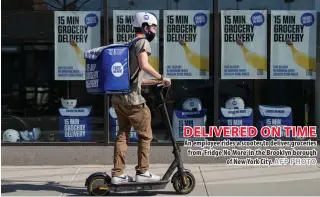  ?? AFP PHOTO ?? DELIVERED ON TIME An employee rides a scooter to deliver groceries from ‘Fridge No More’ in the Brooklyn borough of New York City.