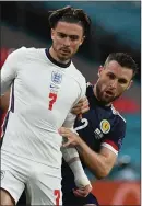  ??  ?? Stephen O’Donnell (right) takes on Jack Grealish at Hampden