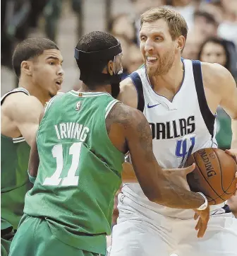  ?? AP PHOTO ?? PRESSURE’S ON: Kyrie Irving and Jayson Tatum pressure the Mavericks’ Dirk Nowitzki during the Celtics’ win Monday night in Dallas.