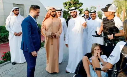  ?? Wam ?? Sheikh Mohammed, Sheikh Hamdan and other officials interact with people during the visit to The Sustainabl­e City on Thursday. —