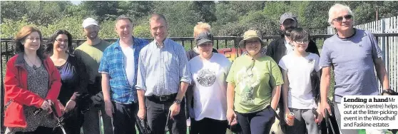  ??  ?? Lending a hand Mr Simpson (centre) helps out at the litter-picking event in the Woodhall and Faskine estates