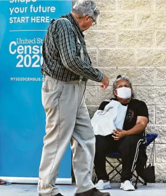  ?? Bob Owen / Staff photograph­er ?? Census worker Mary Martinez sets up in front of the Family Dollar store in CampWood. Camp Wood is in Real County, which has one of the lowest census turnouts in the state.