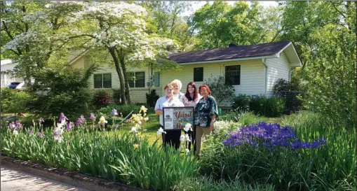  ?? Submitted photo ?? YARD PACKED FULL: The yard of Lin and Jimmy Johnson was chosen as the April Yard of the Month by Garland County Master Gardeners. From left are Master Gardeners Gaye Harper and Carolyn Davis, Christen Mangham, Garvan Woodlawn Gardens membership...