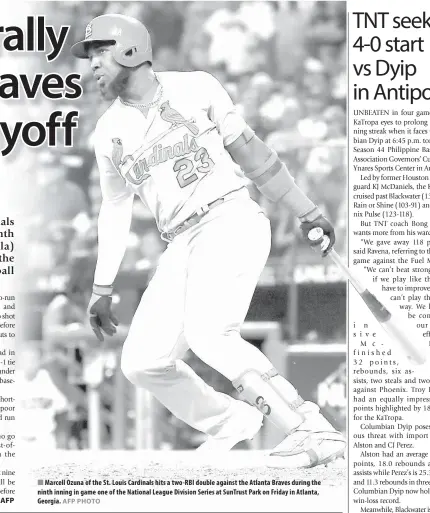  ?? AFP AFP PHOTO ?? Marcell Ozuna of the St. Louis Cardinals hits a two-RBI double against the Atlanta Braves during the ninth inning in game one of the National League Division Series at SunTrust Park on Friday in Atlanta, Georgia.