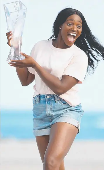  ?? Picture: CLIVE BRUNSKILL/GETTY ?? WINNERS ARE GRINNERS: Sloane Stephens on Crandon Park Beach with the Miami Open trophy after her straight sets victory against Jelena Ostapenko.
