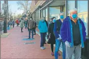  ?? (AP/Carole Feldman) ?? People 65 and older wait outside the Hattie Holmes Senior Wellness Center in Washington to get a coronaviru­s vaccine. The nation’s capital expanded access to the vaccine to older residents a day earlier and demand quickly exceeded supply.