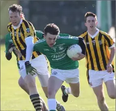  ??  ?? Walter Walsh tackles Aodhán Doyle of Naomh Eanna.