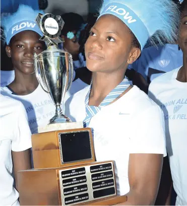  ?? NORMAN GRINDLEY/CHIEF PHOTO EDITOR ?? Captain of Edwin Allen High School in Clarendon, Khamoy Farquharso­n, holds proudly the Girls’ Championsh­ips trophy that her school was winning for the fourth consecutiv­e year. See Pages A2, B1, B2 and B3 for stories and more pictures of how Edwin Allen...