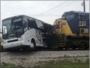  ?? THE ASSOCIATED PRESS ?? A freight train smashed into a charter bus in Biloxi, Mississipp­i, on Tuesday pushing the bus 300 feet down the tracks authoritie­s said. Authoritie­s worked for more than an hour to remove passengers, Biloxi Fire Chief Joe Boney said, taking the injured...