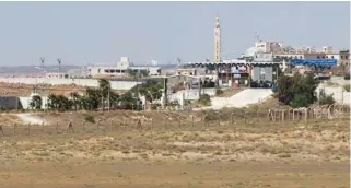  ?? - Reuters file photo ?? CRUCIAL TRANSIT ROUTE: A view of Syrian border checkpoint near Nasib border crossing between Jordan and Syria, as seen from Marafaq, Jordan, September 29, 2018.