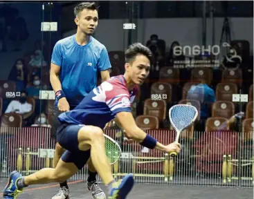  ??  ?? Tough encounter: Ivan Yuen (front) makes a return shot during the semi-final match against Addeen Idrakie. — S. S.KANESAN/ The Star