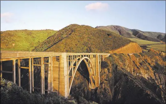  ?? VISIT CALIFORNIA ?? Bixby Creek Bridge is a reinforced concrete open-spandrel arch bridge in Big Sur, California. It is one of the tallest single-span concrete bridges in the world and one of the most photograph­ed bridges along the Pacific Coast because of its aesthetic...