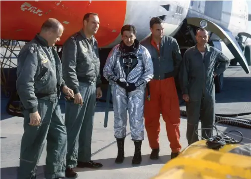  ?? (Photo courtesy of Boeing Archives) ?? NAA test pilot Scott Crossfield made the initial X-15 flights, thus paving the pathway ahead for the others that followed. Clad in a full pressure suit sans helmet, and properly sized to fit in the claustroph­obic X-15 cockpit, Crossfield poses with the flight crew of the NB-52 that carried him and the X-15 aloft.
