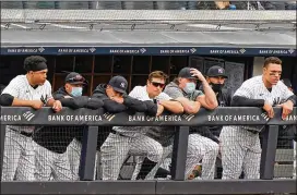  ?? AP ?? Yankees players lean on the dugout railing Sunday during the seventh inning of a loss to the Tampa Bay Rays in New York. From left are designated hitter Giancarlo Stanton, outfielder Brett Gardner, outfielder Jay Bruce (who retired after Sunday’s game), infielder DJ Lemahieu, injured first baseman Luke Voit, a coach and outfielder Aaron Judge.