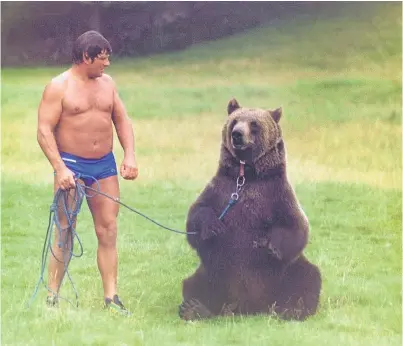  ??  ?? Andy Robin in his wrestling heyday with his best friend, Hercules the bear.