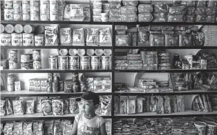  ?? WILLIAM DANIELS/THE NEW YORK TIMES ?? Nestlé products line the shelves of a pharmacy in Muana, Brazil, in July. Across the world, more people are now obese than underweigh­t. At the same time, scientists say, the growing availabili­ty of high-calorie, nutrient-poor foods is generating a new...