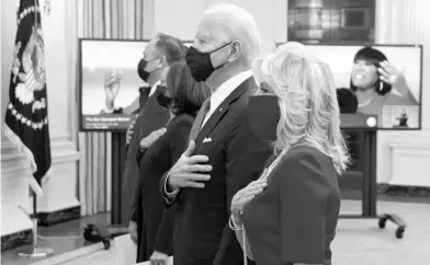  ?? ALEX WONG/GETTY ?? First lady Jill Biden, right, President Joe Biden, Vice President Kamala Harris and second gentleman Doug Emhoff listen to the national anthem Thursday as they watch the virtual presidenti­al inaugural prayer service at the White House.