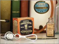  ?? ?? Some of the items in Dr. Toni Brayer's collection of medical artifacts include a formaldehy­de fumigator by the Cenol Company in Chicago in its original box, circa 1919, and a bottle of constipati­on pills by Upjohn in its original bottle with doses listed in grains.