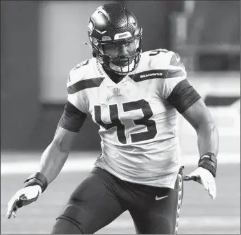  ?? STEPHEN BRASHEAR/AP ?? Seahawks defensive end Carlos Dunlap II rushes the passer in Thursday’s game against the Cardinals in Seattle.