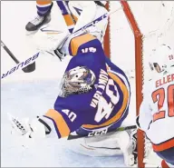  ?? Nathan Denette / Associated Press ?? Islanders goalie Semyon Varlamov makes a glove save on a shot by the Capitals’ Lars Eller on Tuesday night in Toronto.