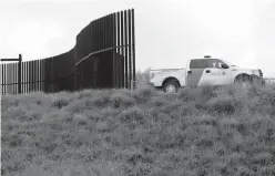  ?? Associated Press ?? n This Nov. 13, 2016, file photo shows a U.S. Customs and Border Patrol agent passing along a section of border wall in Hidalgo, Texas. President Donald Trump will face many obstacles in building his “big, beautiful wall” on the U.S.-Mexico border,...