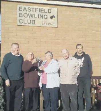  ??  ?? Carol Hill, of Eastfield, hands over the trophy to husband Mick and Geoff Watson, left. Runners-up were Dave Moment and Gary Puleston, right,