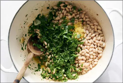  ?? PHOTOS BY DAVID MALOSH — THE NEW YORK TIMES ?? Lemony Pasta with Braised White Beans is prepared in a large pot. Canned beans tend to be starchier and easier to mash into the olive oil in the pan.