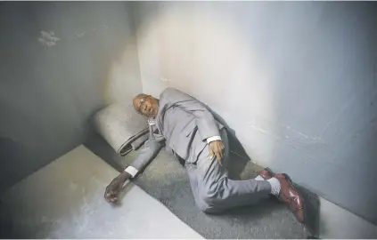  ?? Pictures: EPA ?? EXHIBITION. South African political activist and former political prisoner Andrew Mlangeni demonstrat­es how he used to sleep on the floor in a prison cell on Robben Island yesterday.