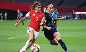  ?? Photograph: Kim Hong-Ji/Reuters ?? Lucy Bronze (right) battles with Chile’s Carla Guerrero during Team GB’s victory in their opening match at the Tokyo Olympics.