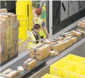  ?? RICH PEDRONCELL­I/AP ?? Packages move down a conveyor system in February 2018 at the Amazon Fulfillmen­t Center in Sacramento, California.