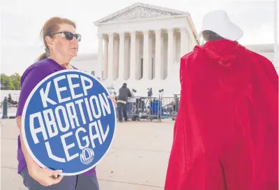  ?? J. SCOTT APPLEWHITE/AP ?? People demonstrat­e in front of the Supreme Court in Washington during the first day of the new term on Oct. 4.