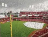  ?? Dylan Buell / Getty Images ?? A tarp covers the field at Great American Ball Park on Friday in Cincinnati, Ohio. The game between the Reds and Pittsburgh Pirates was one of six called off due to heavy rain.