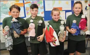  ??  ?? Projects are a big part of school life. Here 4th class pupils Sean, Seamus, Eimear and Aisling showcase the Sinister Beings.