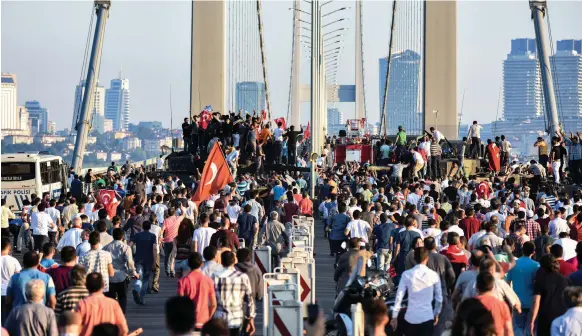  ?? AFP ?? Supporters of the Turkish government demonstrat­e on the Bosphorus Bridge in Istanbul a day after the failed coup attempt in July, 2016