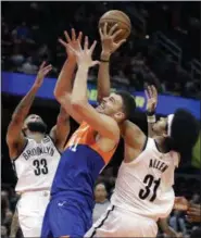  ?? TONY DEJAK — THE ASSOCIATED PRESS ?? The Nets’ Allen Crabbe (33), Jarrett Allen and the Cavaliers’ Ante Zizic vie for the ball on Feb. 13 at The Q.