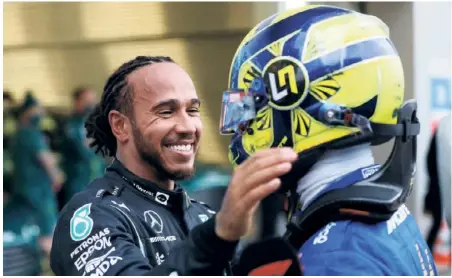  ?? GETTY IMAGES ?? Tough luck: Lewis Hamilton of Mercedes hugs Lando Norris of Mclaren in parc ferme during the F1 Grand Prix of Russia at Sochi Autodrom. Narros made a judgement error on changing the tyres and conceded a win to Hamilton.