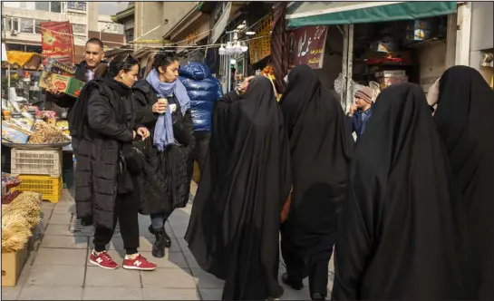  ?? PHOTOS BY ARASH KHAMOOSHI — THE NEW YORK TIMES ?? Women without head coverings shop in Tehran on Jan. 28. Defiant resistance to Iran’s mandatory hijab law has spread across the country after nationwide protests that erupted last year.