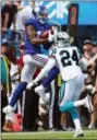  ?? JASON E. MICZEK — THE ASSOCIATED PRESS ?? New York Giants’ Odell Beckham (13) catches a pass as Carolina Panthers’ James Bradberry (24) defends in the first half of an NFL football game in Charlotte, N.C., Sunday.