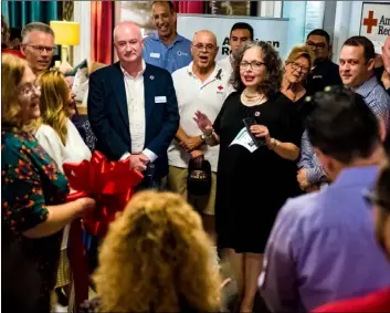 ?? PHOTO VINCENT OSUNA ?? Sylvia Preciado-Platero, manager of the American Red Cross’ imperial Valley Service Center, (middle) gives opening remarks during a ribbon cutting ceremony Thursday morning for the Red Cross’s new El Centro location inside Furniture Palace on Main Street in El Centro.