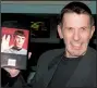  ?? Democrat-Gazette file photo ?? Actor Leonard Nimoy shows a photo of himself as Star Trek’s Mr. Spock. Nimoy wrote two books that deal with his conflicted feelings about the character: I Am Not Spock (1975) and I Am Spock (1995).