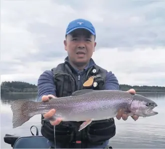  ??  ?? Lake landing Peter Lee with a fine specimen caught on Lake of Menteith