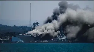  ?? DENIS POROY — THE ASSOCIATED PRESS ?? Smoke rises from the USS Bonhomme Richard at Naval Base San Diego after an explosion and fire Sunday on board the ship. The cause of the fire remains under investigat­ion.